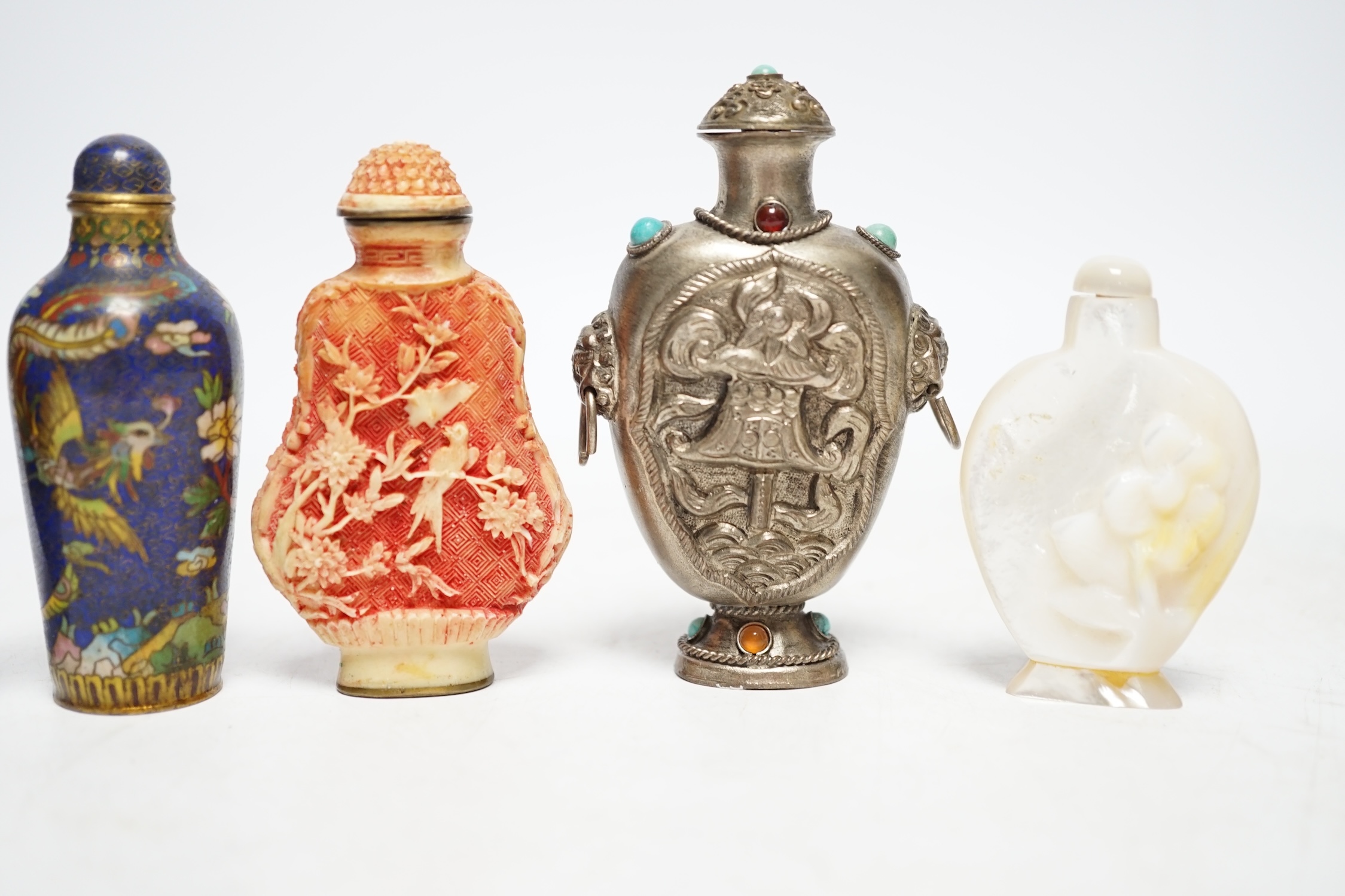 A Chinese cloisonné enamel snuff bottle, two resin snuff bottles, a carved mother of pearl snuff bottle and a Tibetan style metal snuff bottle, largest 8.5cm high
